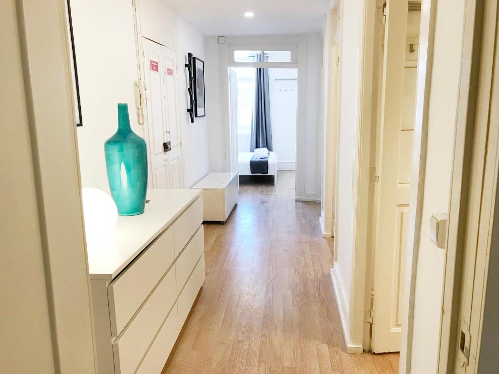 um corredor com um vaso azul sentado numa cómoda em D'ouro no Porto