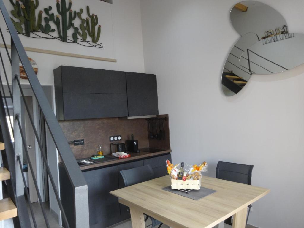 uma cozinha com uma mesa de madeira e uma sala de jantar em Les Cigalines em Saint-Cyprien-Plage