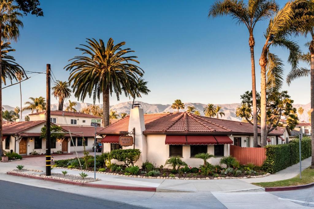 a house on a street with palm trees at Harbor House Inn in Santa Barbara