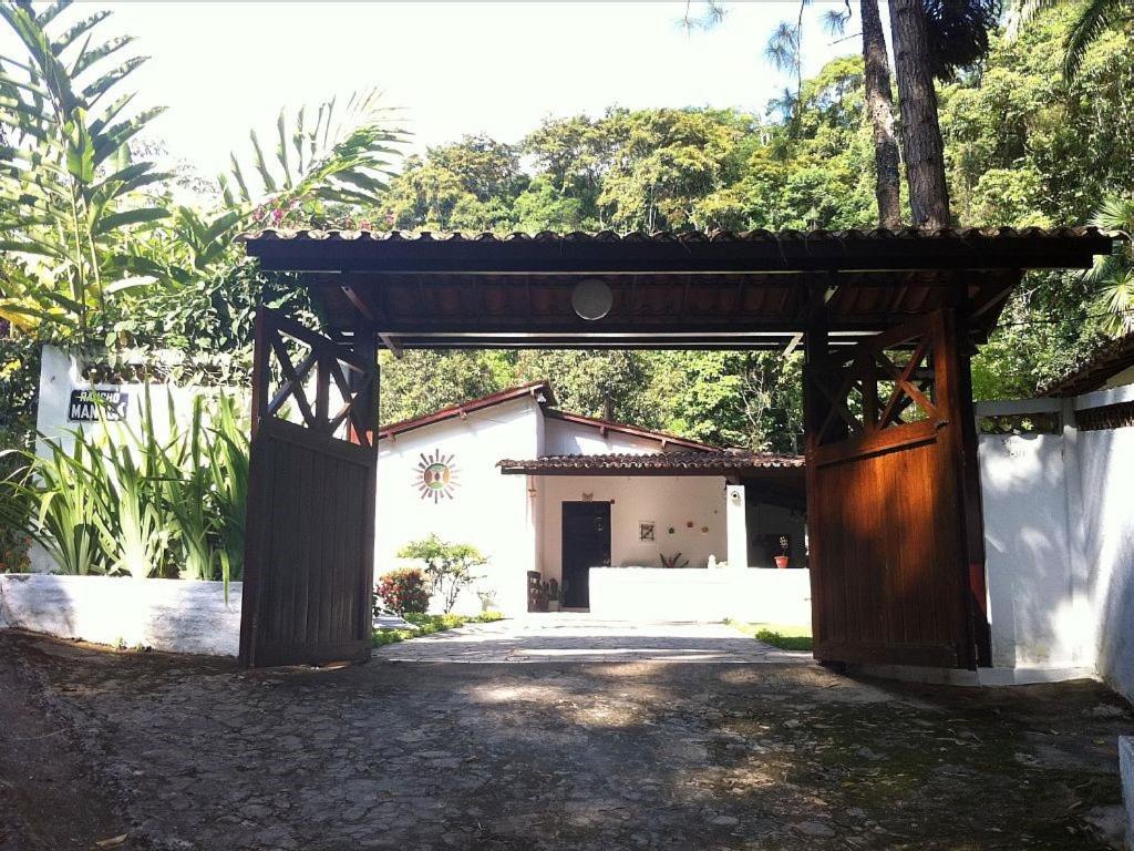 an entrance to a building with a wooden gate at Rancho Manacá in Guaramiranga