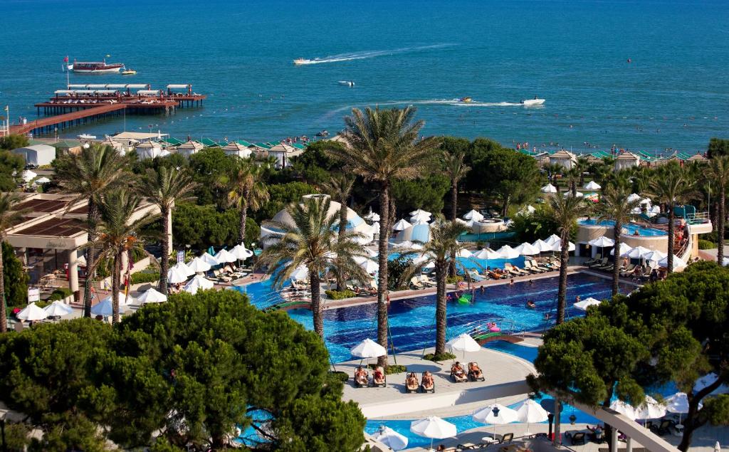 a view of a resort with a pool and the ocean at Limak Atlantis Deluxe Hotel Belek in Belek