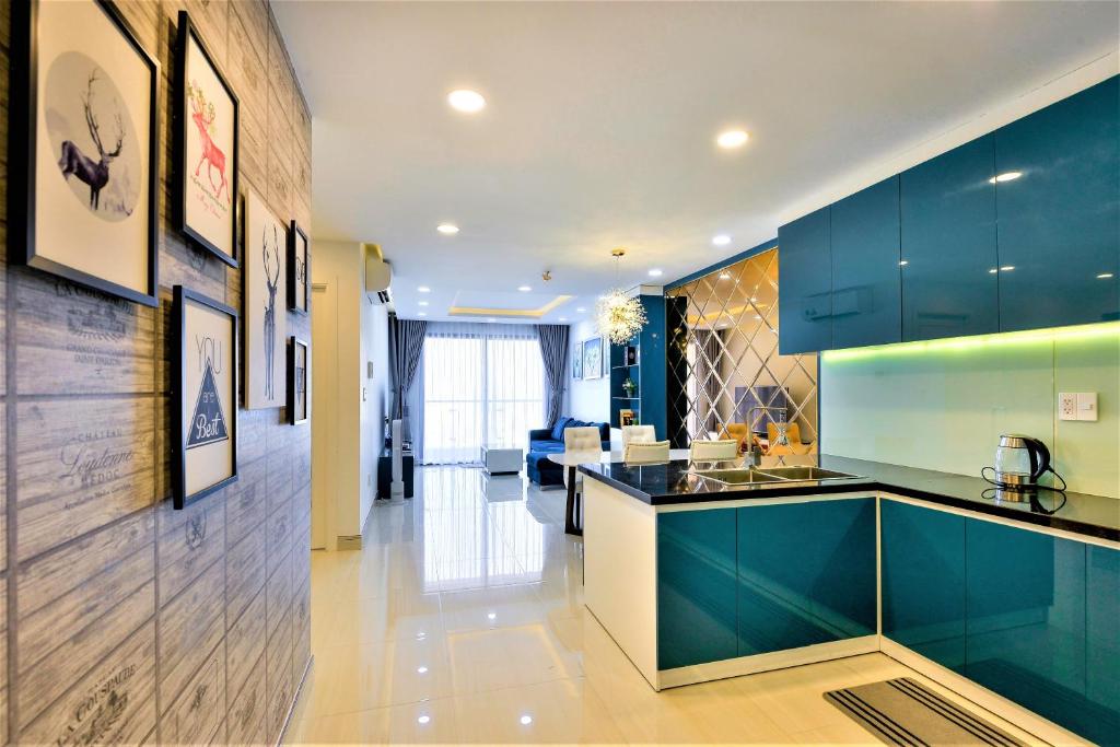 a kitchen with blue cabinets and a counter top at Căn hộ Quận 4 GoldView Aparment in Ho Chi Minh City