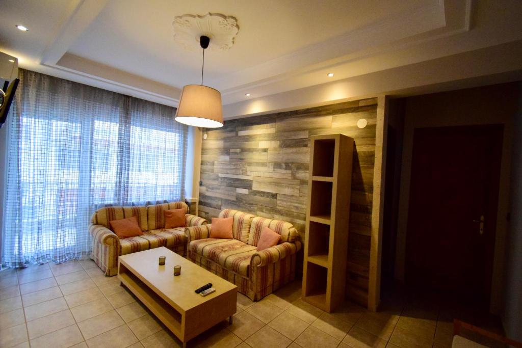 a living room with a couch and a table at Feeling Home in Thessaloniki