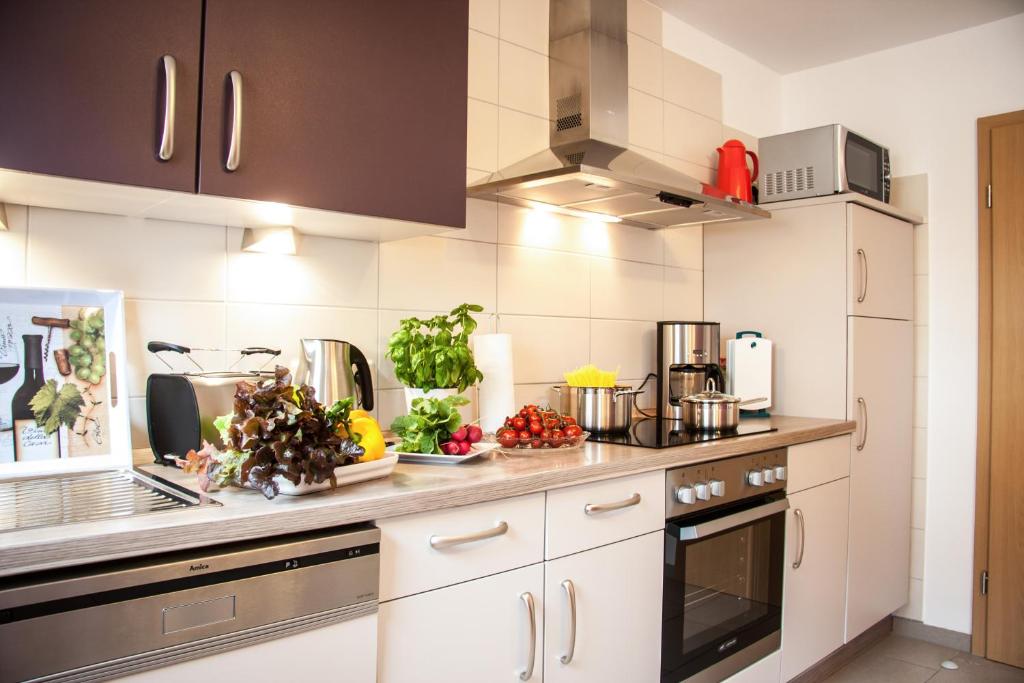 a kitchen with a counter with fruits and vegetables on it at Das Moseltor zu Koblenz in Lehmen