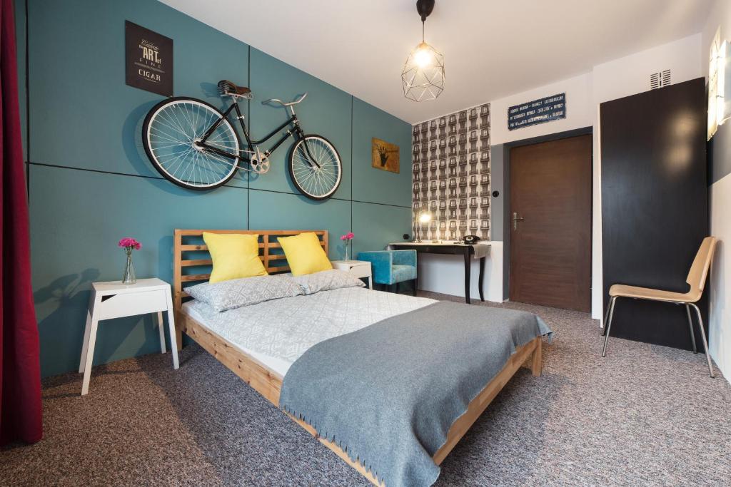 a bedroom with a bed with a bike on the wall at Willa Pod Łosiem in Krynica Zdrój