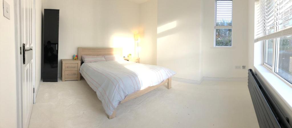 a white bedroom with a bed and a window at Kings Lynn, Double bedroom, newly renovated bathroom in King's Lynn