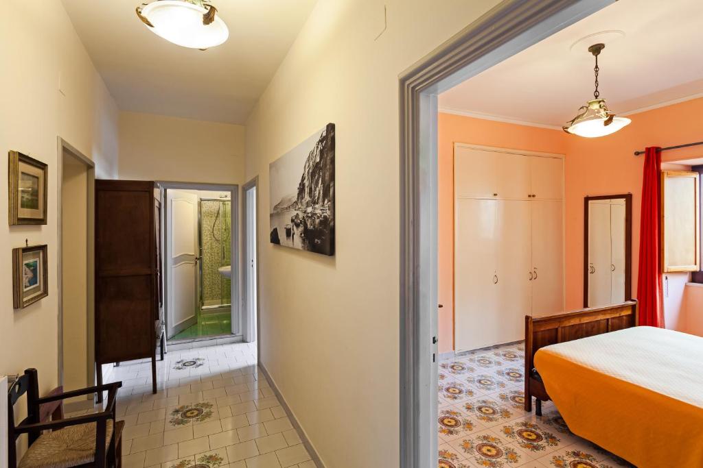 a bedroom with a bed and a door to a hallway at Residenza Sorrentina in Sorrento