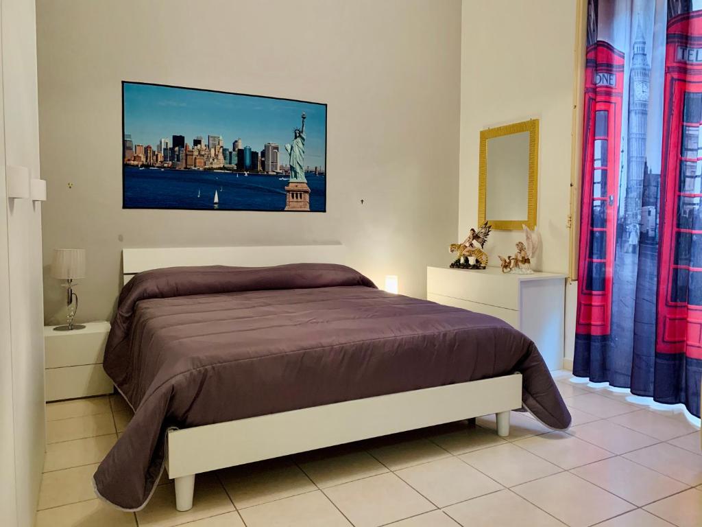 sypialnia z dużym łóżkiem i dużym obrazem na ścianie w obiekcie Monfenera Apartment 2 w mieście Palermo