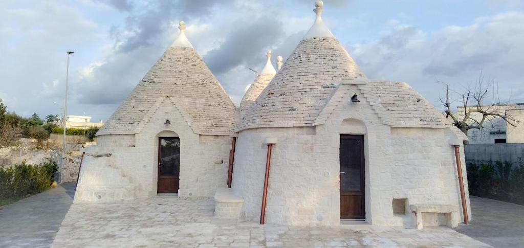 a small white building with two towers on top at RITORNO AD ITACA in Locorotondo