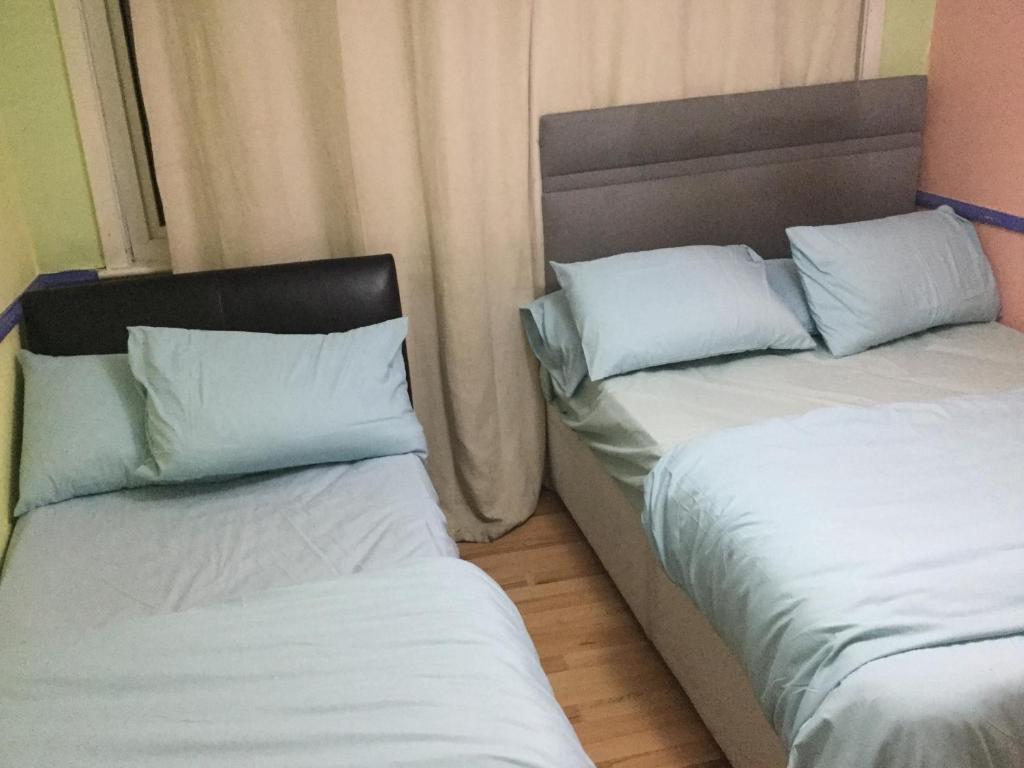 two beds sitting next to each other in a room at Holiday / vacation Double Room in Greater manchester in Summerseat