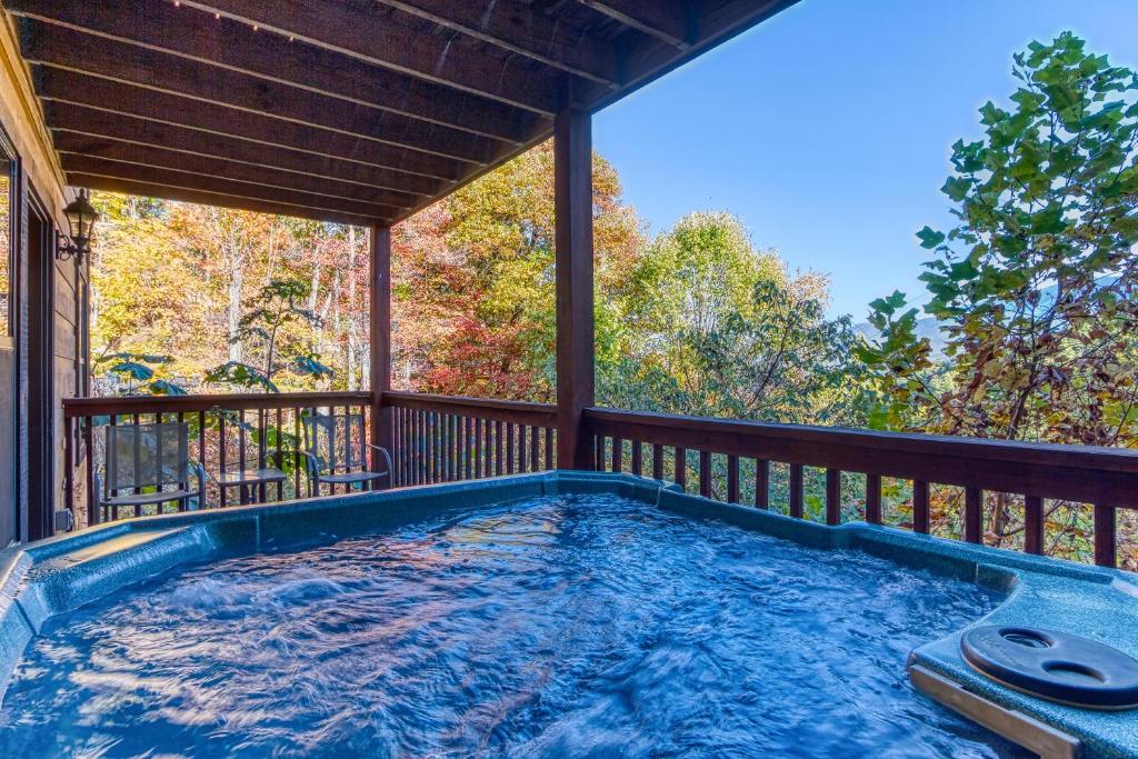 a hot tub on the deck of a house at Daya in Gatlinburg