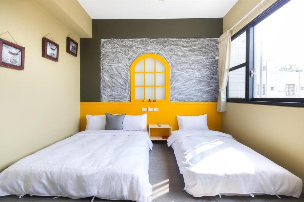 Postel nebo postele na pokoji v ubytování 東立方旅宿-East Cube B&B