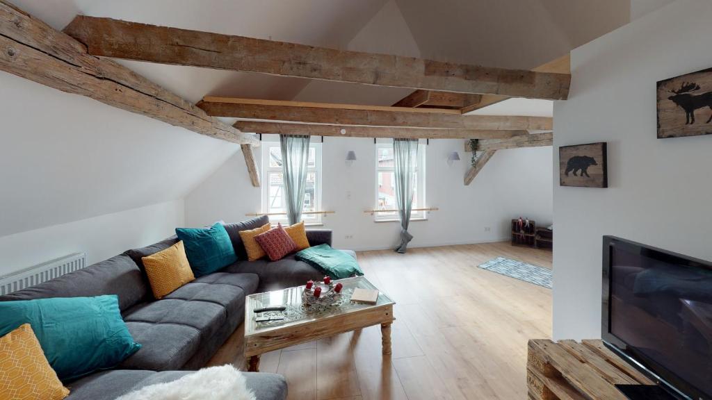 a living room with a couch and a tv at Ihr Zuhause in Jakobi's Straße in Goslar