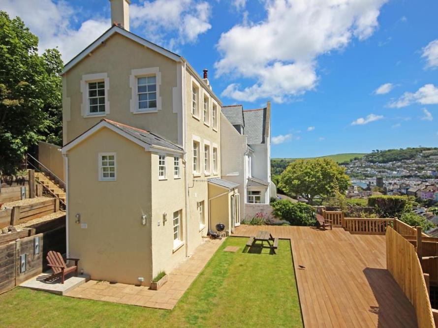 a large white house with a patio and grass at Fairview House in Dartmouth