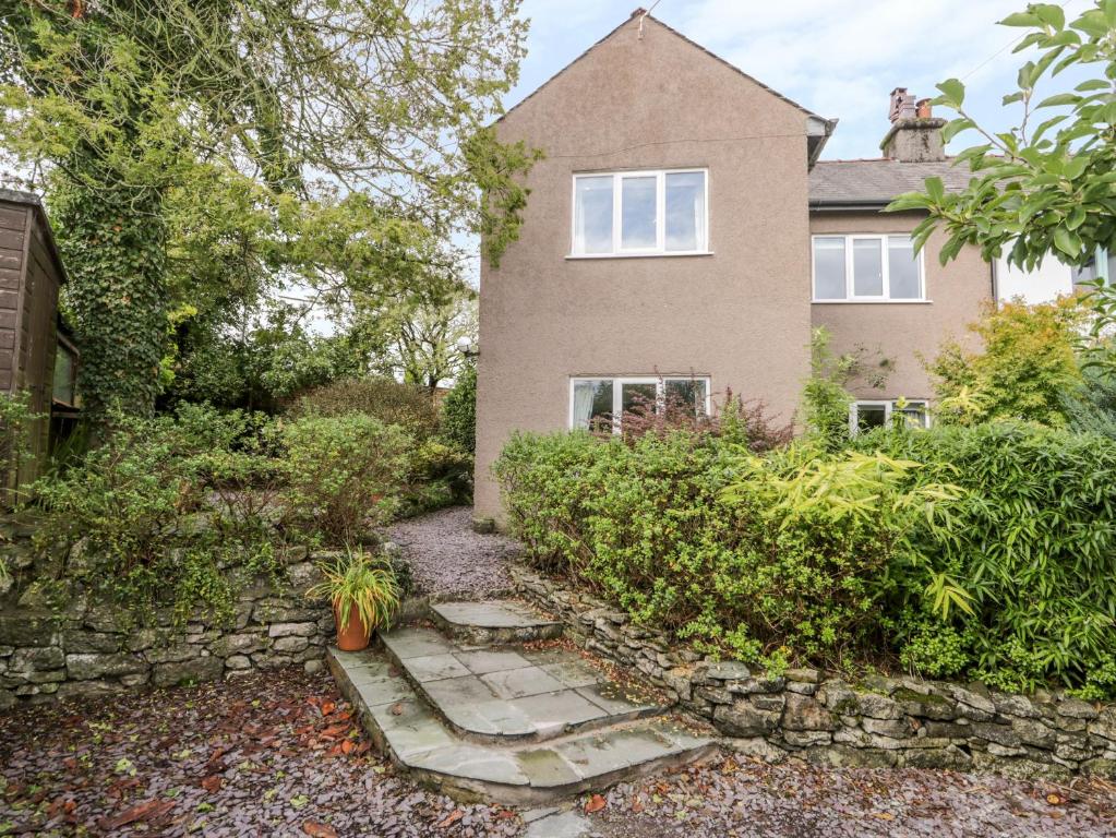 a house with a stone path in front of it at Crossways in Grange Over Sands