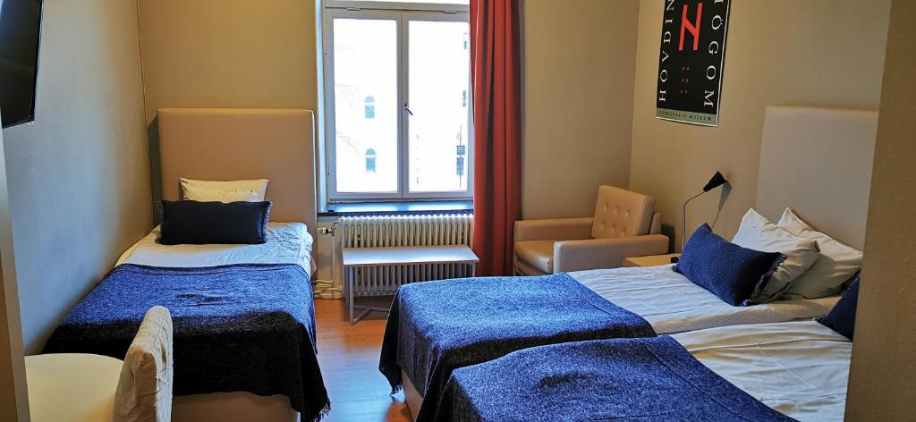 Postel nebo postele na pokoji v ubytování Sundsvall City Hotel