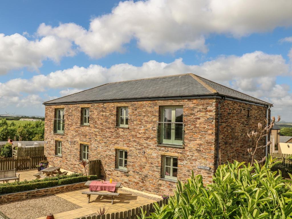 a brick house with a patio in front of it at Hawthorn Cottage in Truro