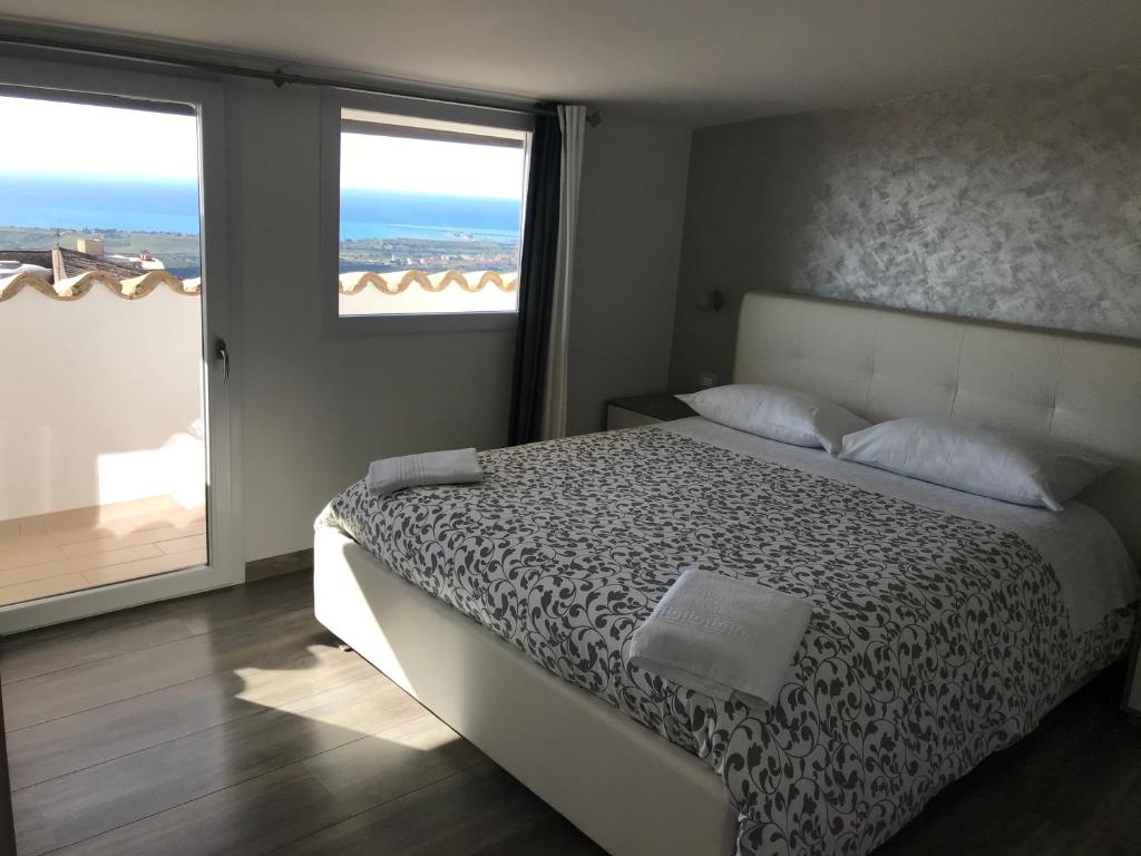 a bedroom with a bed and a large window at Casa di Cecè in Agrigento