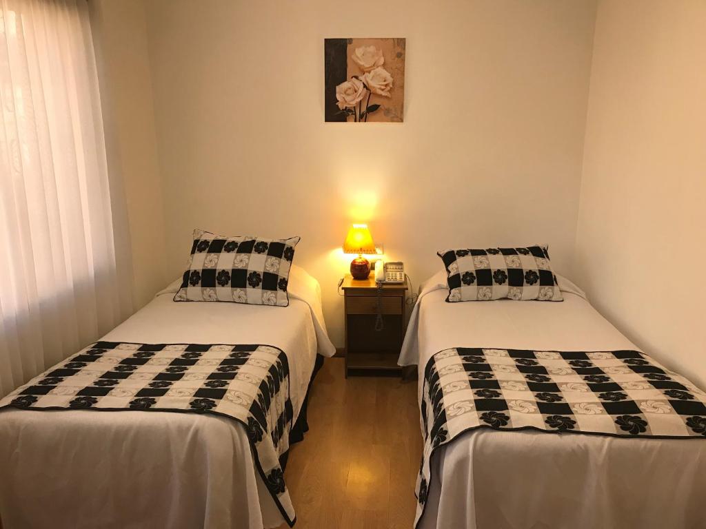 Postel nebo postele na pokoji v ubytování Hotel Luanco