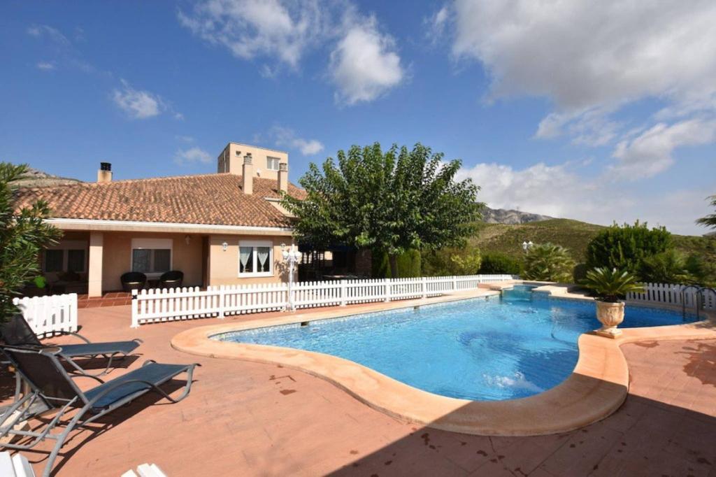 a swimming pool in front of a house at Torreta Of Gormaig, House with swimming pool in Gormach