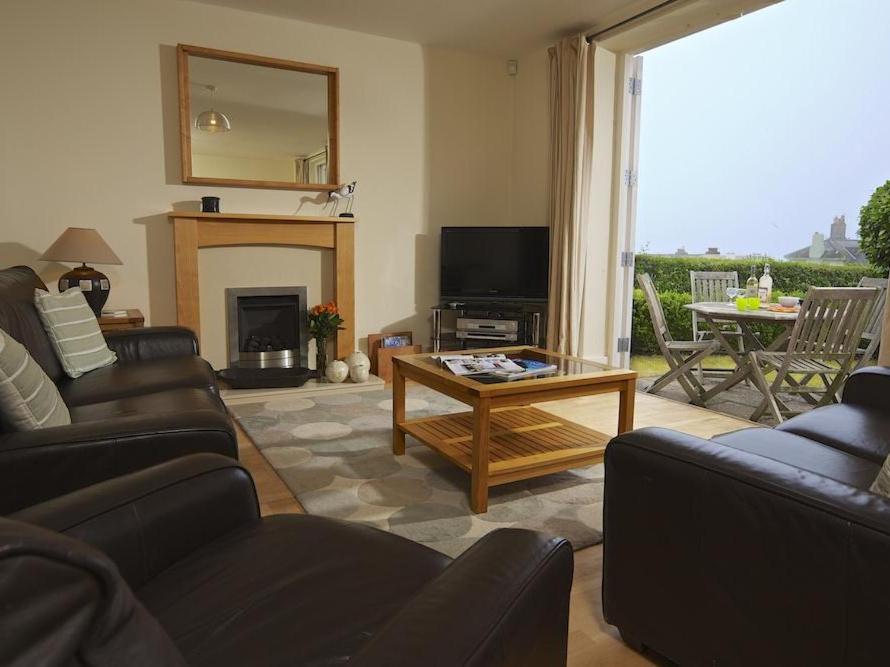 a living room with a couch and a table at 3 Combehaven in Salcombe