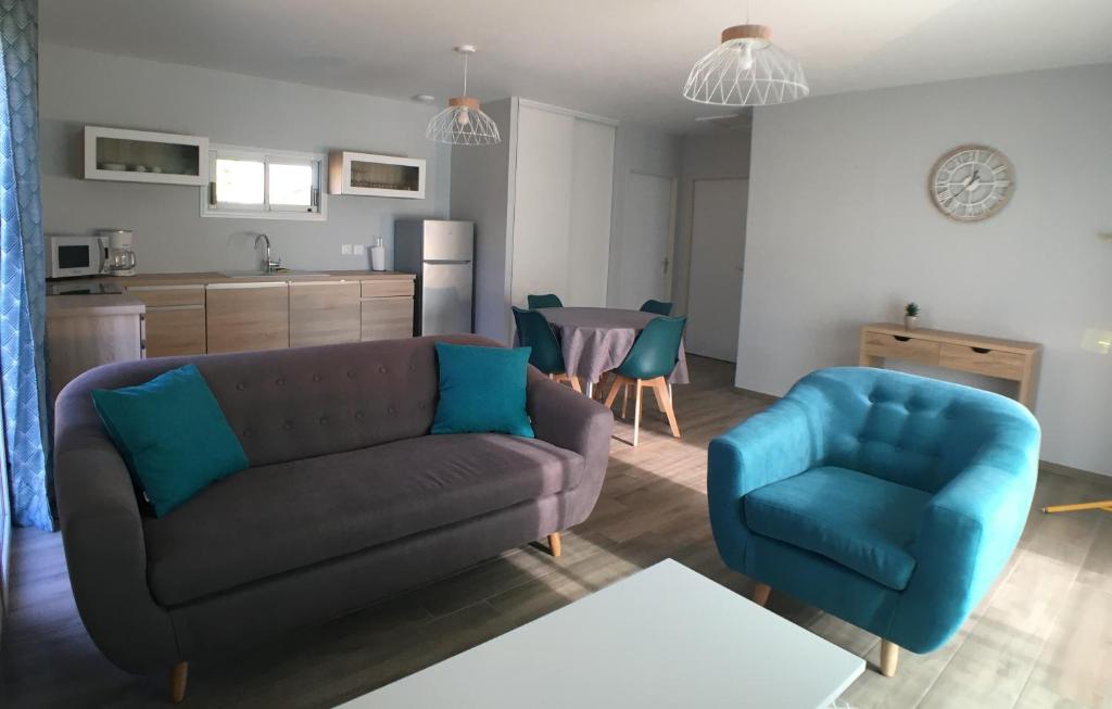 Hameau de Biscaye في Varetz: غرفة معيشة مع أريكة وكرسي أزرق