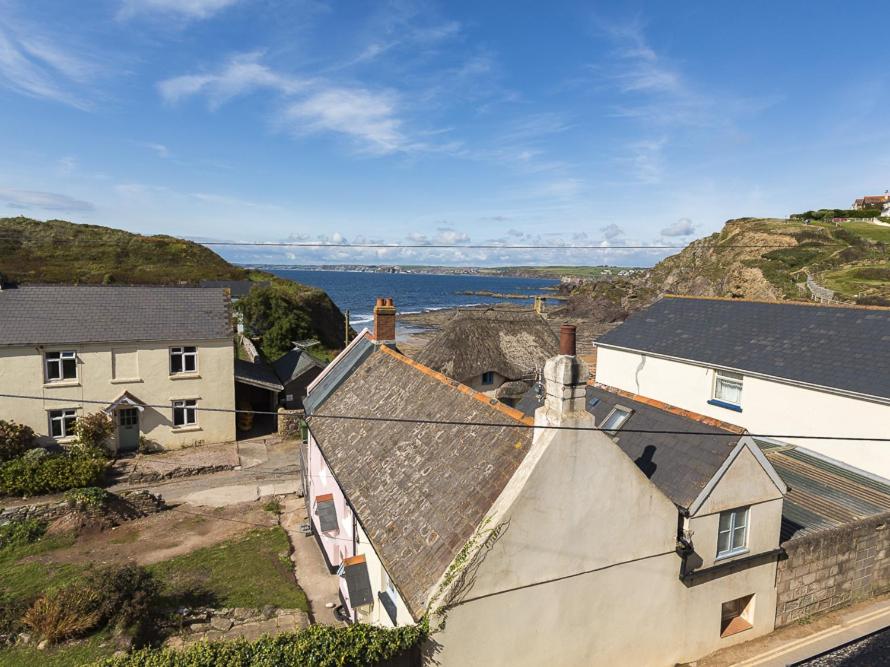 an aerial view of a house with the ocean in the background at 4 Armada House in Hope Cove