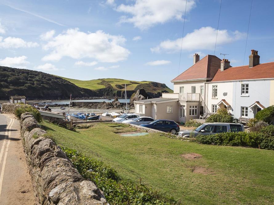 a group of cars parked in front of a house at 4 Armada House in Hope Cove