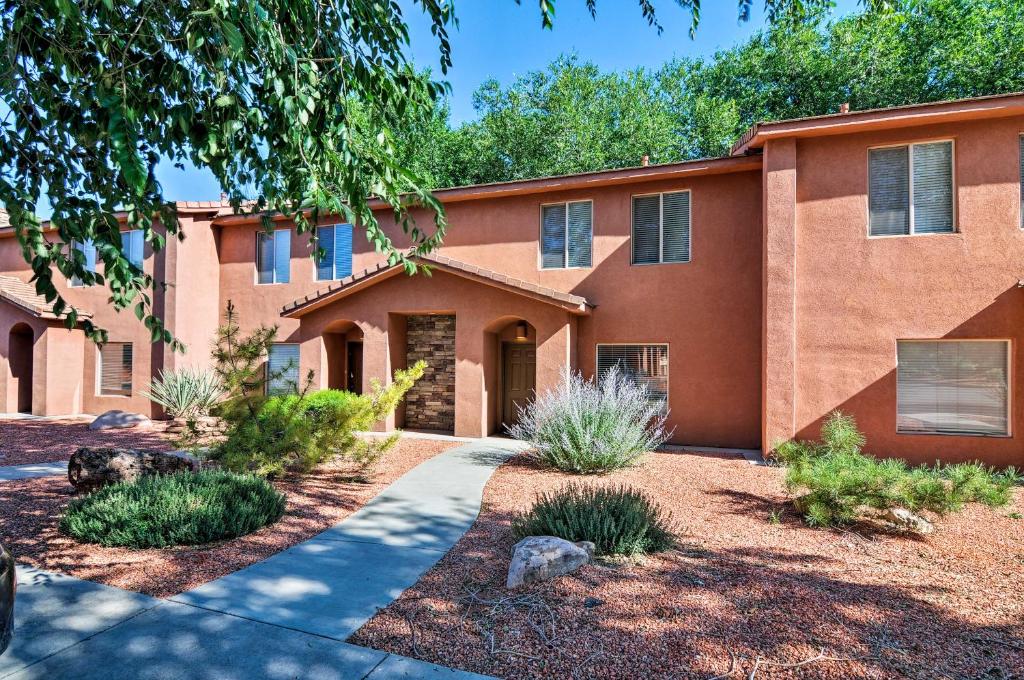 a large brick building with a driveway in front at Kanab Condo with Pool and AC Less Than 1 Mi to Attractions! in Kanab