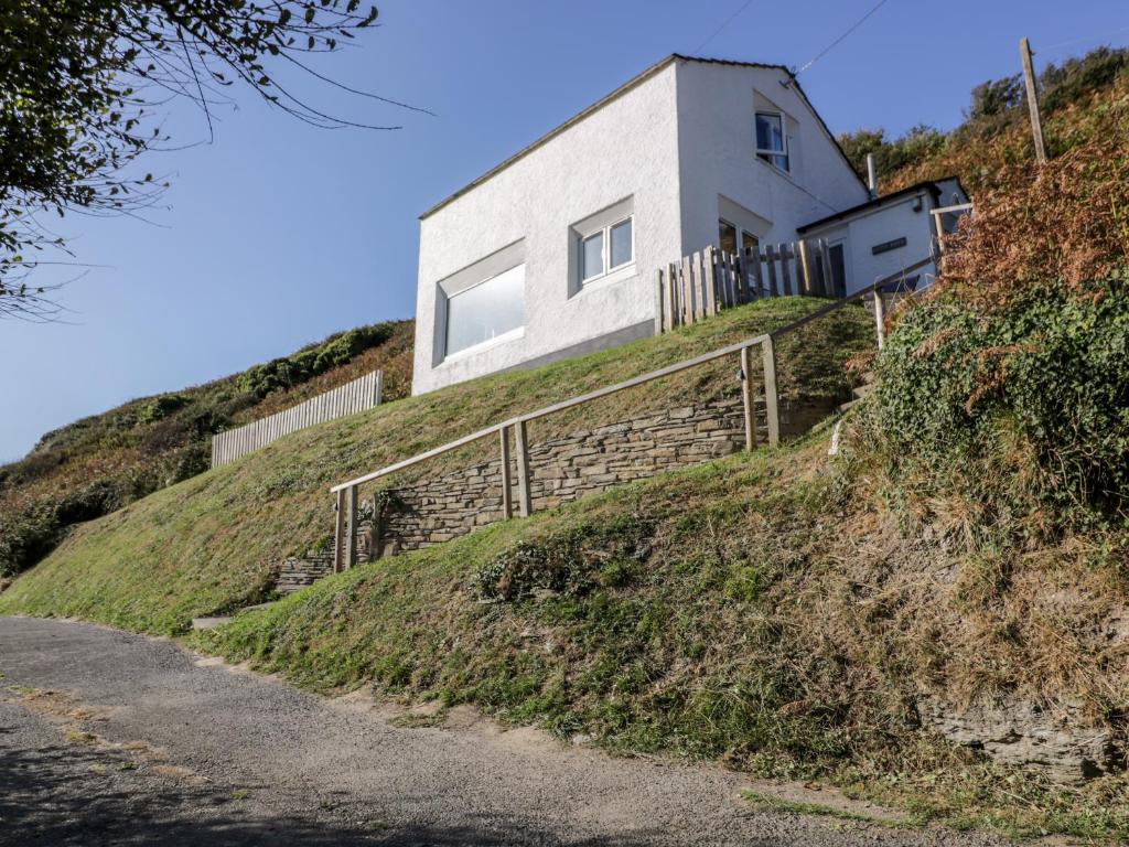 uma casa no lado de uma colina em Little Ruffo em Tintagel
