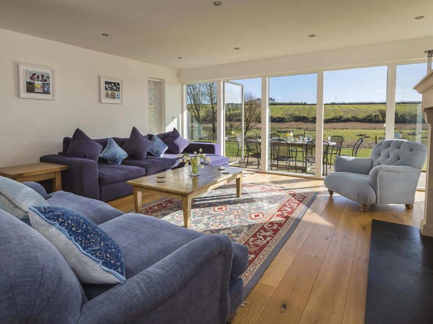 a living room with a couch and a table at Sea Peep in Thurlestone