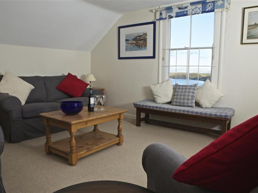 a living room with a couch and a table at 7 Glenthorne House in Salcombe