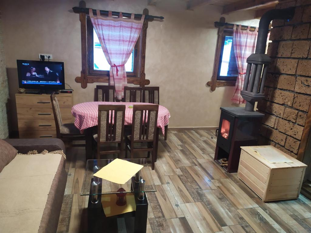 a living room with a fireplace and a stove at Vila Balerina in Mitrovac