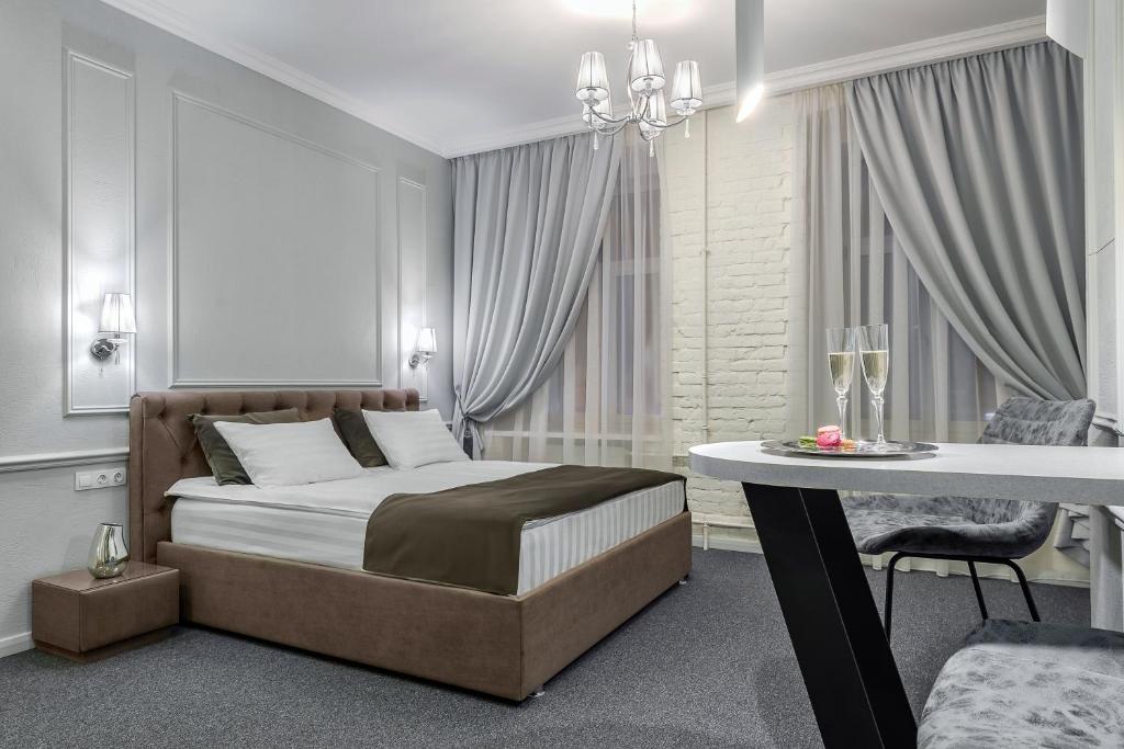 a bedroom with a bed and a table in it at Staronevsky Dom in Saint Petersburg