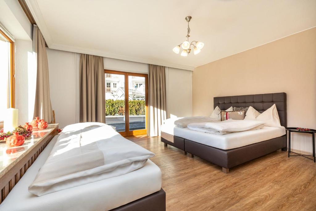 Posteľ alebo postele v izbe v ubytovaní Herzerl-Chalet Appartements