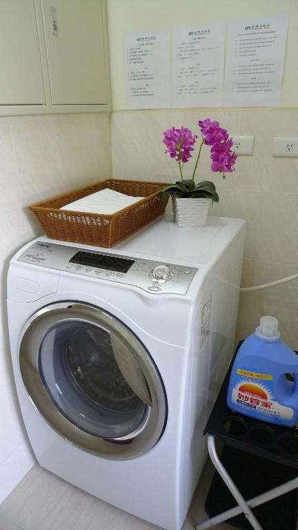 a washing machine with a basket on top of it at Fuward Hotel Tainan in Tainan
