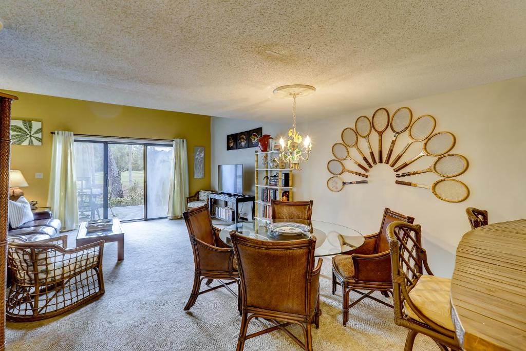 a dining room and living room with a table and chairs at Greens 198 in Hilton Head Island