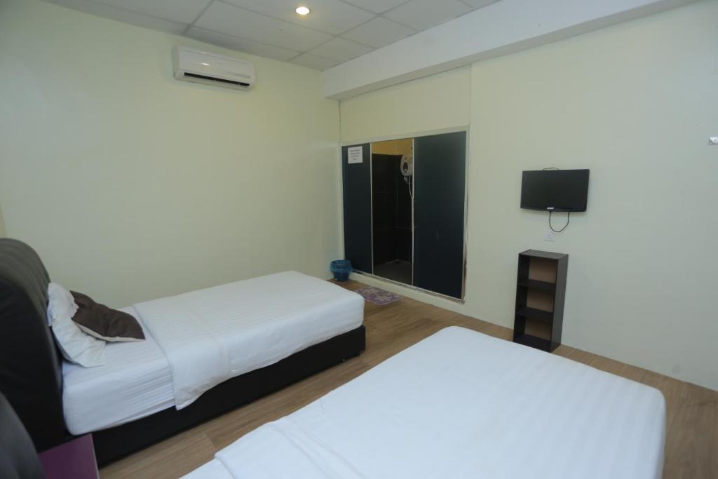 Postel nebo postele na pokoji v ubytování JAM Hotel Kota Warisan Sepang @ ERL Salak Tinggi, KLIA 1-2 & F1
