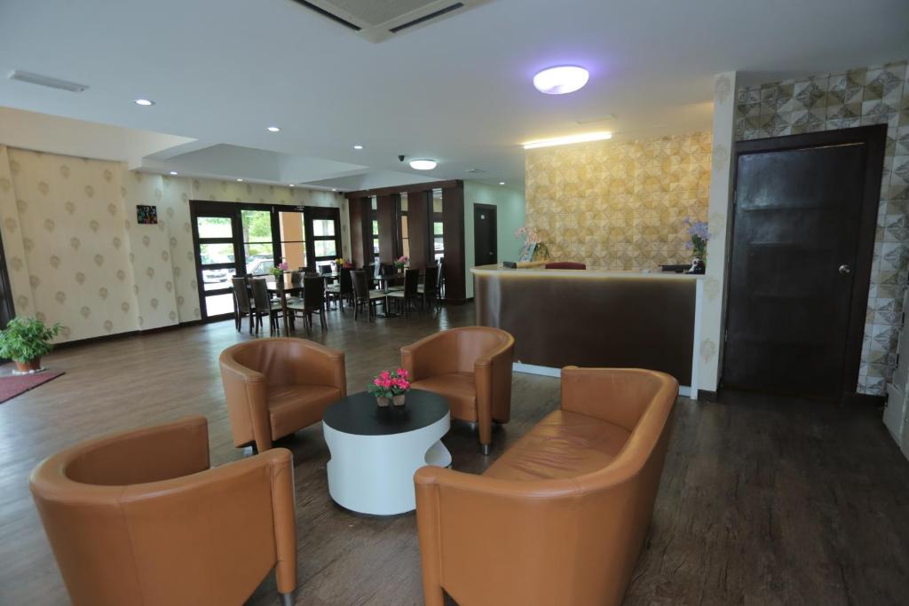 a lobby with chairs and a bar in the background at JAM Hotel Kota Warisan Sepang @ ERL Salak Tinggi, KLIA 1-2 & F1 in Sepang