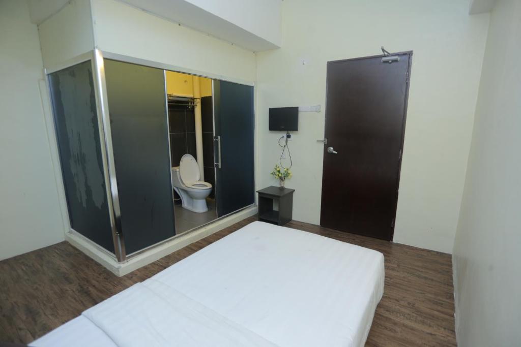 Postel nebo postele na pokoji v ubytování JAM Hotel Kota Warisan Sepang @ ERL Salak Tinggi, KLIA 1-2 & F1