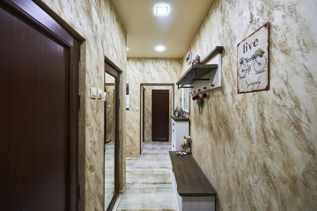 a hallway with a wall with writing on it at Apartment AlPreMira in Varna City