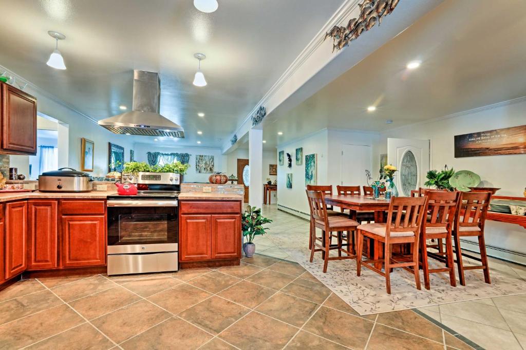 a kitchen and dining room with a table and chairs at Expansive Getaway about 2 Miles to Mendenhall Glacier! in Mendenhaven