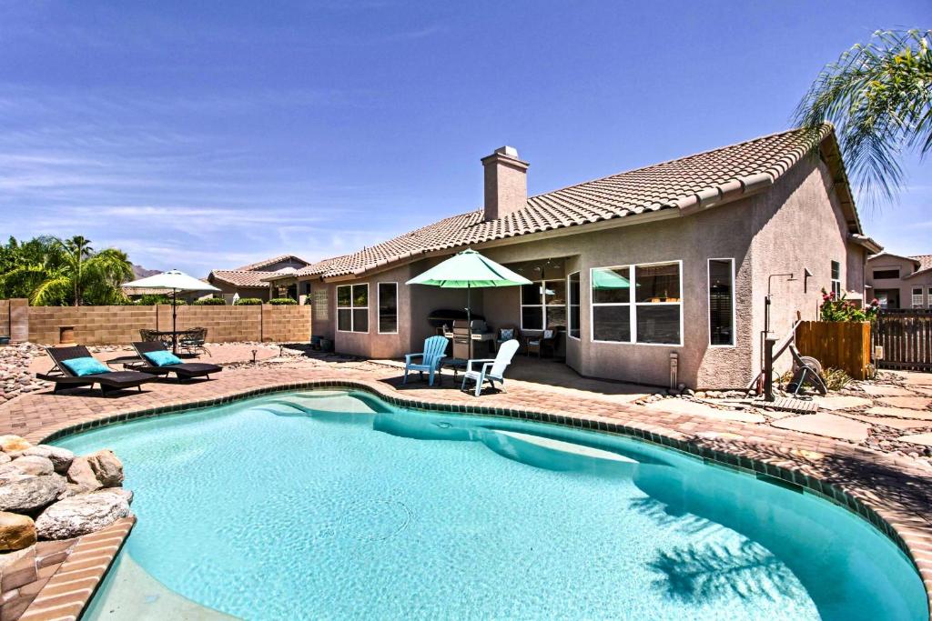 a swimming pool in front of a house at Tucson Home with Pool and Santa Catalina Mtn Views in Tucson