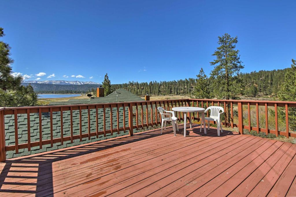 a wooden deck with a table and two chairs on it at Walk to Lake Cabin with Deck and Views in Fawnskin in Fawnskin