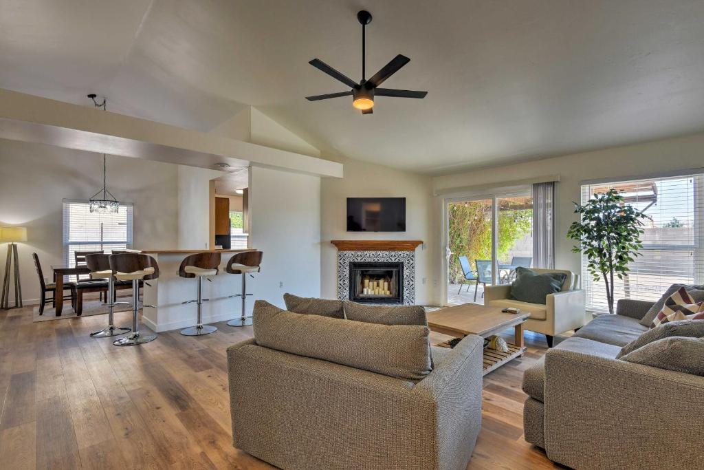 a living room with a couch and a fireplace at Updated Mesa Home with Spacious Backyard and Fire Pit! in Mesa
