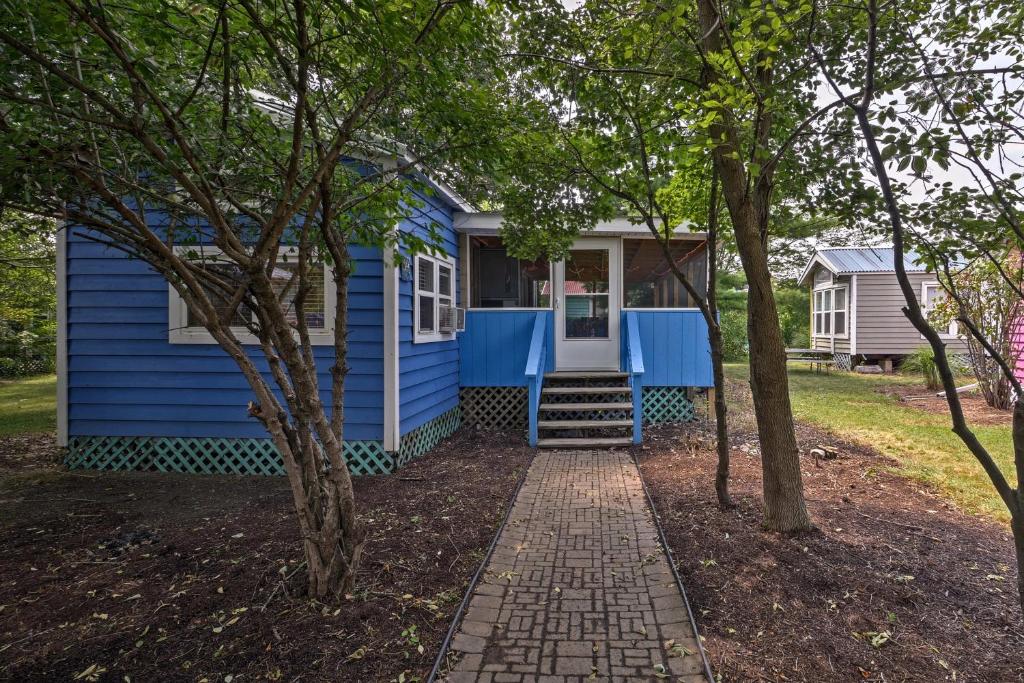 a blue house with a pathway leading to it at Middle Bass Island Home - Pool and Hot Tub Access! in Put-in-Bay