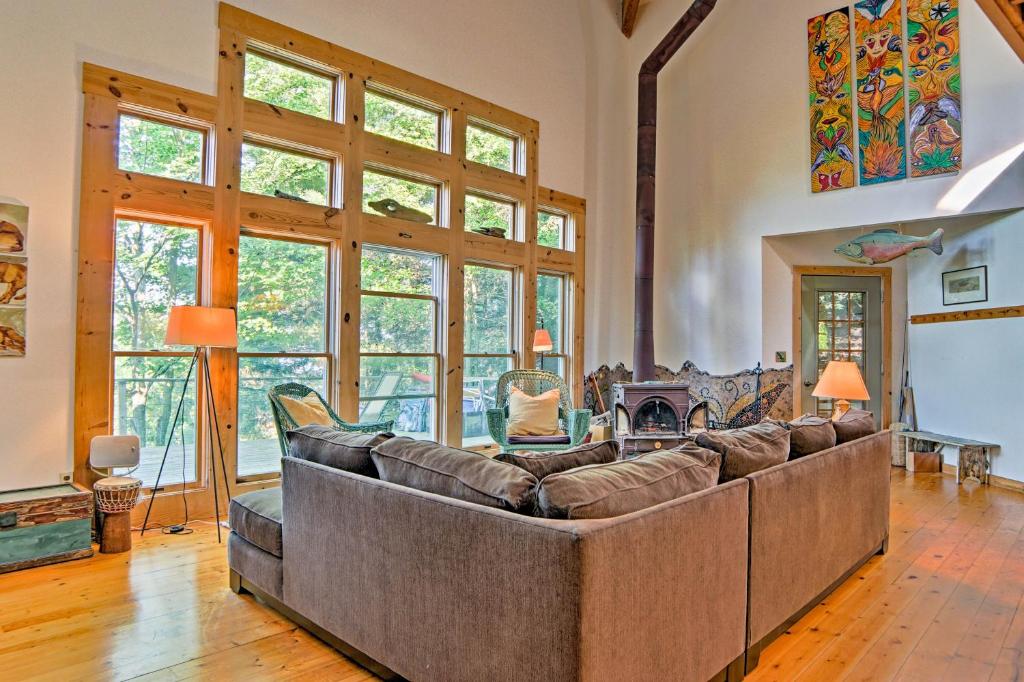 a large living room with a couch and a fireplace at Forested Pentwater Vacation Rental - Walk to Beach in Pentwater