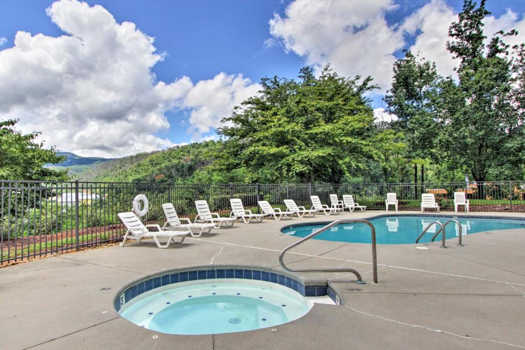 a swimming pool with lounge chairs and a swimming pool at Gatlinburg Condo with Smoky Views Walk to Town! in Gatlinburg