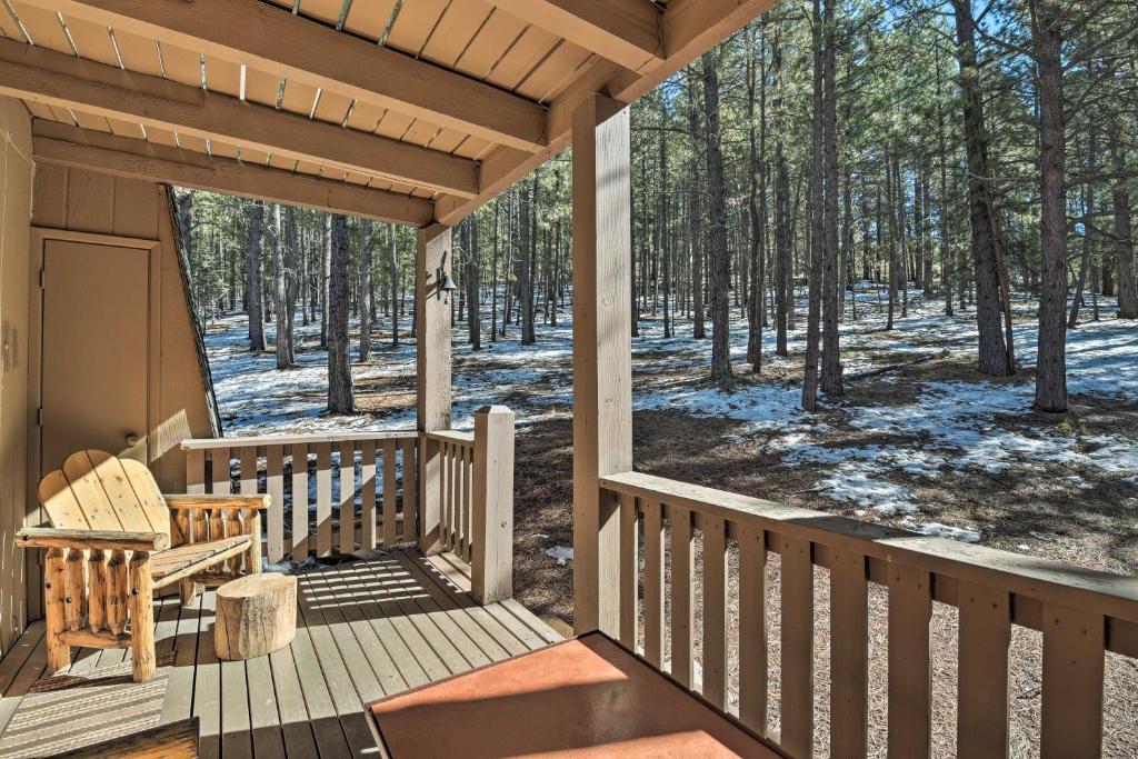 a porch of a cabin with snow on the ground at Rustic Condo with Patio Walk to Angel Fire Resort! in Angel Fire