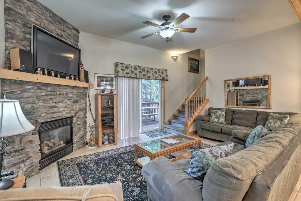 a living room with a couch and a fireplace at Carnelian Bay Home with Hot Tub Near Tahoe Skiing in Carnelian Bay